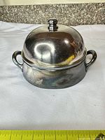 Covered dish assembled showing lid, handles and tarnish