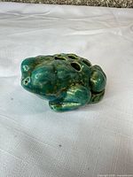 angled front view of ceramic frog flower frog