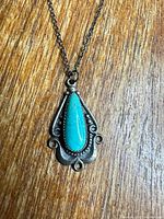Front view of sterling silver pendant with turquoise stone on chain