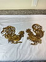 Both rooster plaques side by side on white background
