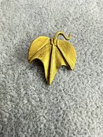 Front angled view of brass leaf brooch