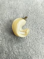 front view of pearlescent glass crescent pendant with bail