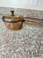 Saucepan with lid side view on countertop