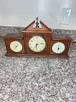 Full frontal view showing all three dials and wood case