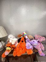 Group of all nine stuffed animals on table
