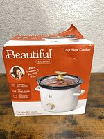 Front of box showing Beautiful 2 qt slow cooker image and branding