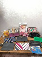 Group shot showing all twelve wallets, wristlets and clutches