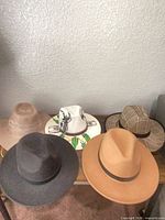Group shot of five hats showing variety of styles and colors