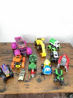 Group shot showing all ten vehicles on wooden surface
