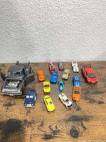 Full group of approximately 15 die-cast vehicles on tabletop