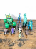 Group shot showing all eight dinosaur toys