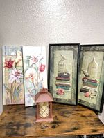 Full lot: two canvas panels, two framed prints, metal lantern with candle