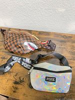 Both waist bags side by side on table