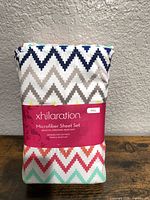 Front of sealed package showing Xhilaration branding and chevron pattern