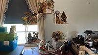 Overall view of rack with birdhouses and figurines