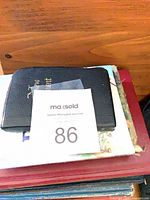 Stack showing pocket New Testament atop illustrated children’s Bible and others