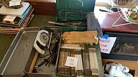 Overall view of toolbox with tools, rulers, gloves, green saw case