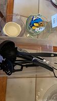 Overview of utensils in plastic bin, glass bowls, measuring jug
