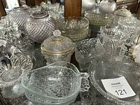 Cabinet shelf with entire lot showing various pressed glass pieces