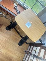 Top view of bamboo table surface with visible wear and black metal frame