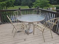 Patio set on deck showing table and four chairs