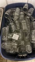 Tote filled with numerous clear pint mason jars