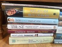 Left stack of seven titles including Billy Graham, Joyce Meyer, Iyanla Vanzant, Tim Storey, Joel Osteen and Psalms/Proverbs volume