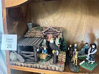 Overall view of rustic cabin and surrounding figurines