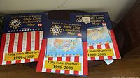 Three closed maps showing front covers and titles