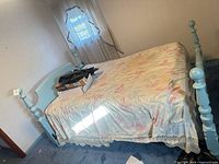 Full view of assembled light blue wooden bed frame with headboard and footboard