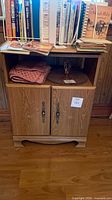 Front view of cabinet with open shelf and double doors