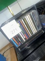 Front view of crate showing row of CDs with labels
