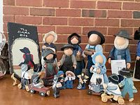 Group shot showing majority of figurines and plaque