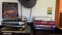 Overall view of stacked ex-library hardcovers with visible dust jackets and spine labels