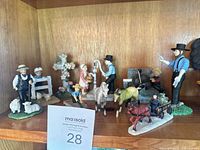Overall view of all nine resin farm figurines on shelf