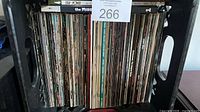 Crate filled with numerous comic books spine-out