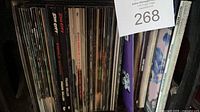 Spines of numerous comic books stacked upright showing variety of titles