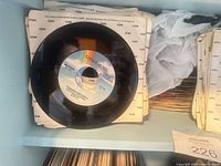 Stack of MCA 7-inch singles in sleeves with one record on top