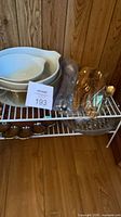 Full lot showing ceramic bowls, carnival glass bowl below, flatware bag, clear platter