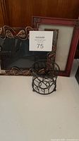 All three items together: metal leaf frame, red wood frame, round metal tealight holder