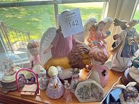 Overall view of nine angel and religious items on windowsill