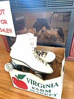 White quad roller skates in cardboard box