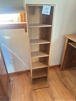 Full front view showing oak veneer and all seven shelves