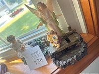 Guardian angel and child figurines displayed on windowsill