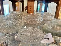 Overview of multiple pressed glass bowls and divided relish dish