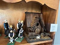 Full view birdhouse and figurines on shelf
