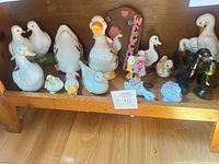 Shelf with full assortment of duck, goose and floral figurines