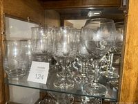Front view of multiple stemmed goblets on shelf