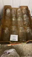 Top view of tray with 12 clear glass mason jars showing sizes and condition