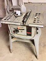 Front view of ShopCraft table saw on stand with handwheel, rip fence and miter gauge visible